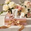 Luxe Women's Birthday Gift Box with perfume, skincare and chocolates in blush pink box with gold ribbon