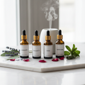 Luxe Aromatherapy Essential Oils Set with 6 amber glass dropper bottles on marble with dried flowers